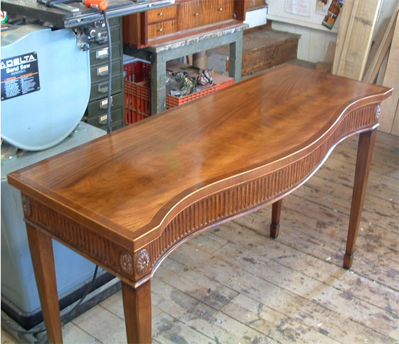 A refinished table completed at the workshop of Billings Woodworking